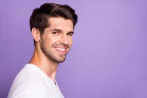 Man smiling with full head of hair after NeoGraft hair transplant in La Jolla, CA