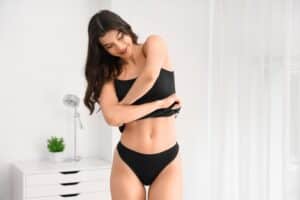 Woman in bra and underwear looking slim after CoolSculpting treatment in La Jolla, CA