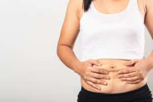 Woman's loose skin around her abdomen from weight loss in La Jolla, CA