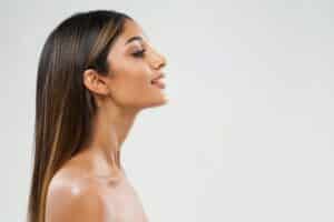 Side profile of woman's face with a defined jawline from a chin implant in La Jolla, CA